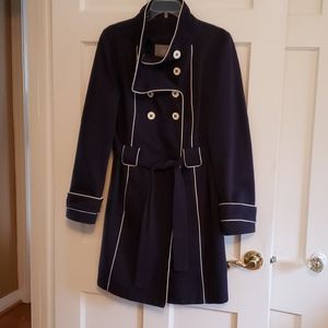 Navy blue coat with white trim and stand up collar